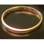 AN 18TH CENTURY WEDDING BAND The flat section gold band, with italic inscription to inner face and