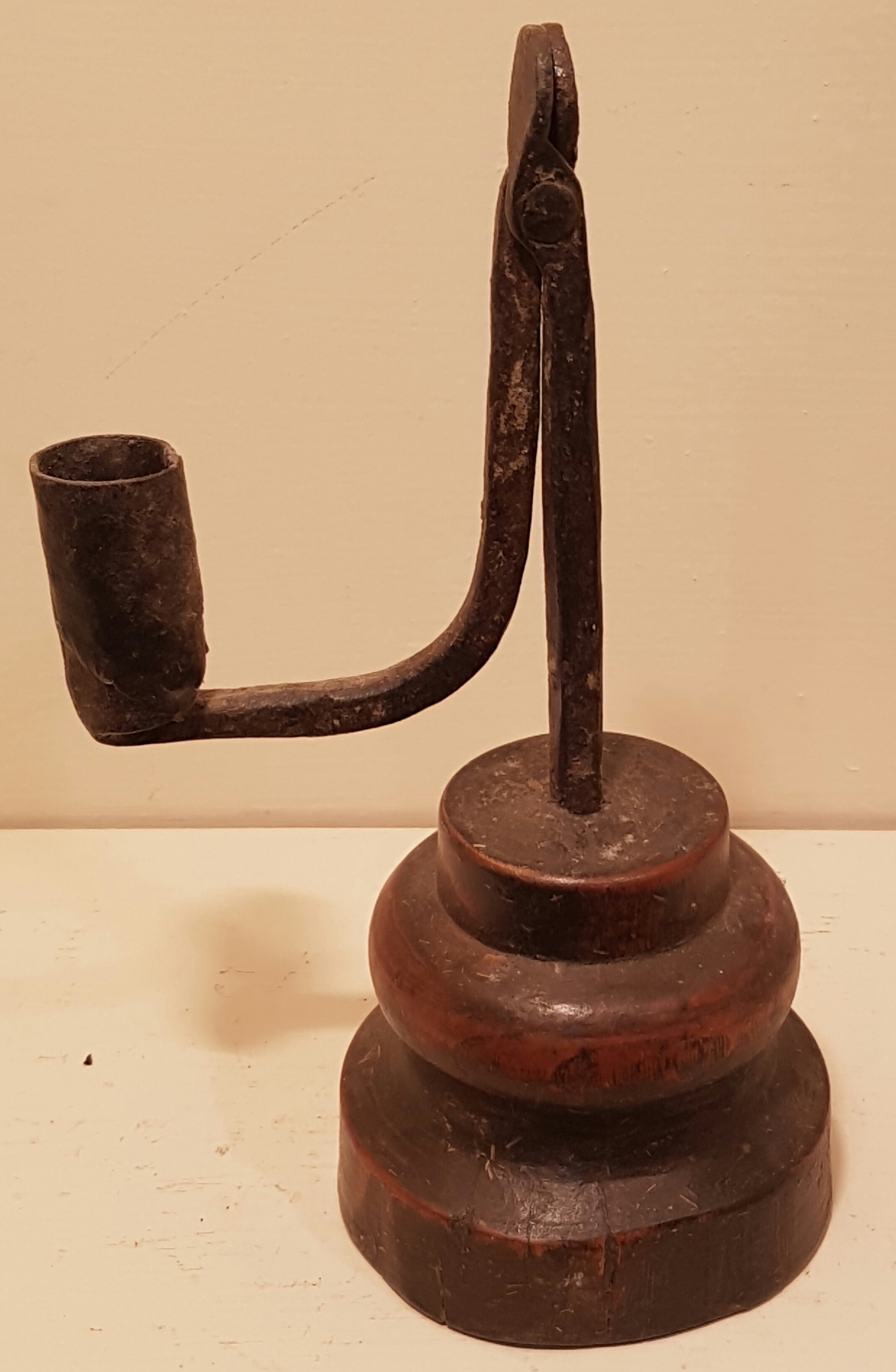 AN 18TH CENTURY IRON TABLE RUSHLIGHT HOLDER AND CANDLE SOCKET With circular grip and bracket arm,