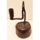 AN 18TH CENTURY IRON TABLE RUSHLIGHT AND CANDLE SOCKET Of spiral stem and bracket arm, raised on a