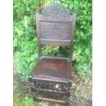 A 17TH CENTURY NORTH COUNTRY OAK STANDARD CHAIR With a carved panelled back, solid seat and raised