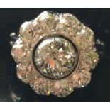 A VICTORIAN DIAMOND CLUSTER DRESS RING A flowerhead cluster of old cut diamonds claw set in