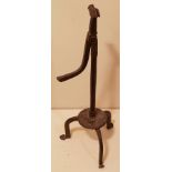 AN IRON TABLE RUSHLIGHT With fish tail grip, the tripod base with drip pan disc mount. Condition: