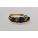 AN 18CT GOLD, SAPPHIRE AND DIAMOND RING The three round cut sapphires, interspersed with two round