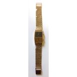 BAUME ET MERCIER, A VINTAGE 18CT GOLD TWIN TIME ZONE WRISTWATCH On 9ct gold strap.