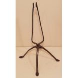 AN 18TH/19TH CENTURY IRON TABLE CANDLE HOLDER With spring double stem grip, raised on four slender