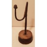 AN 18TH CENTURY IRON TABLE RUSHLIGHT HOLDER In the form of a 'U' arm with acorn knop terminal,