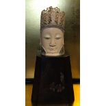 A 19TH CENTURY CHINESE IVORY HEAD OF A BUDDHA Crested with a figural finial and pierced crown,