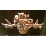 A VICTORIAN PERIOD DIAMOND AND GEM SET BROOCH Designed as a basket of flowers, between two small