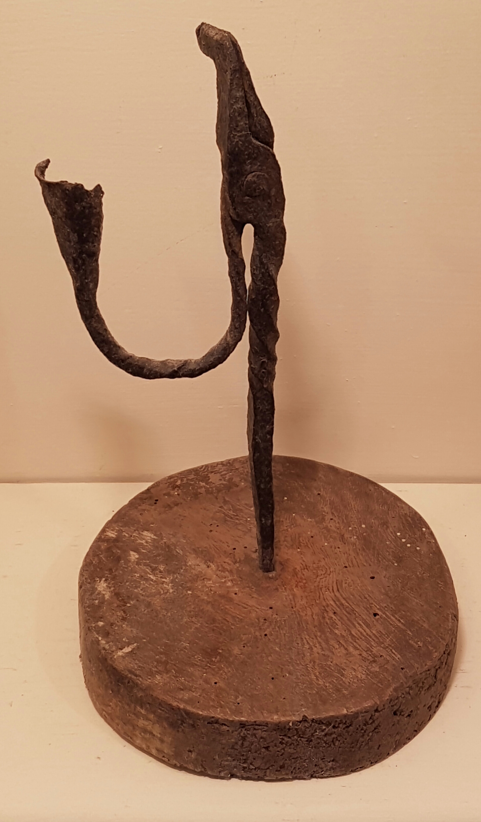 AN 18TH CENTURY IRON RUSHLIGHT AND CANDLE SOCKET The upper stem and 'U' shaped arm, with spiral