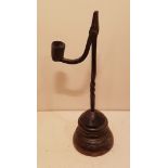 AN IRON TABLE RUSHLIGHT AND CANDLE SOCKET With partial spiral twist stem, set on a turned and