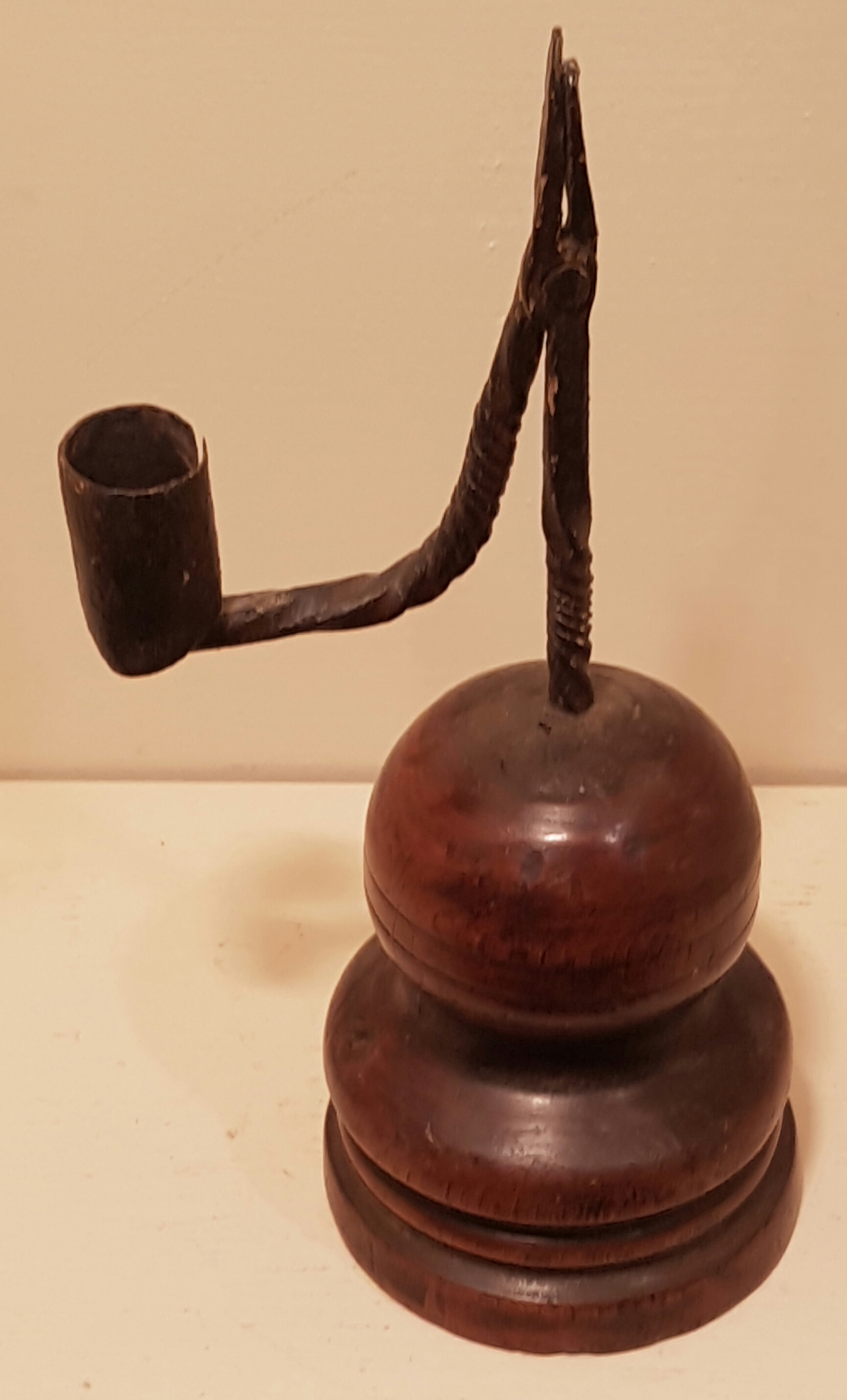 AN 18TH CENTURY IRON TABLE RUSHLIGHT AND CANDLE SOCKET The short stem and bracket arm, with spiral