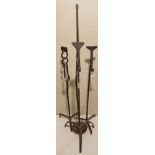 THREE ANTIQUE WROUGHT IRON FLOOR STANDING RUSH HOLDERS Along with a single iron pricket. (tallest