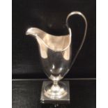 A GEORGIAN SILVER CREAM EWER Of classical tapering shape, with a loop handle and hallmarked