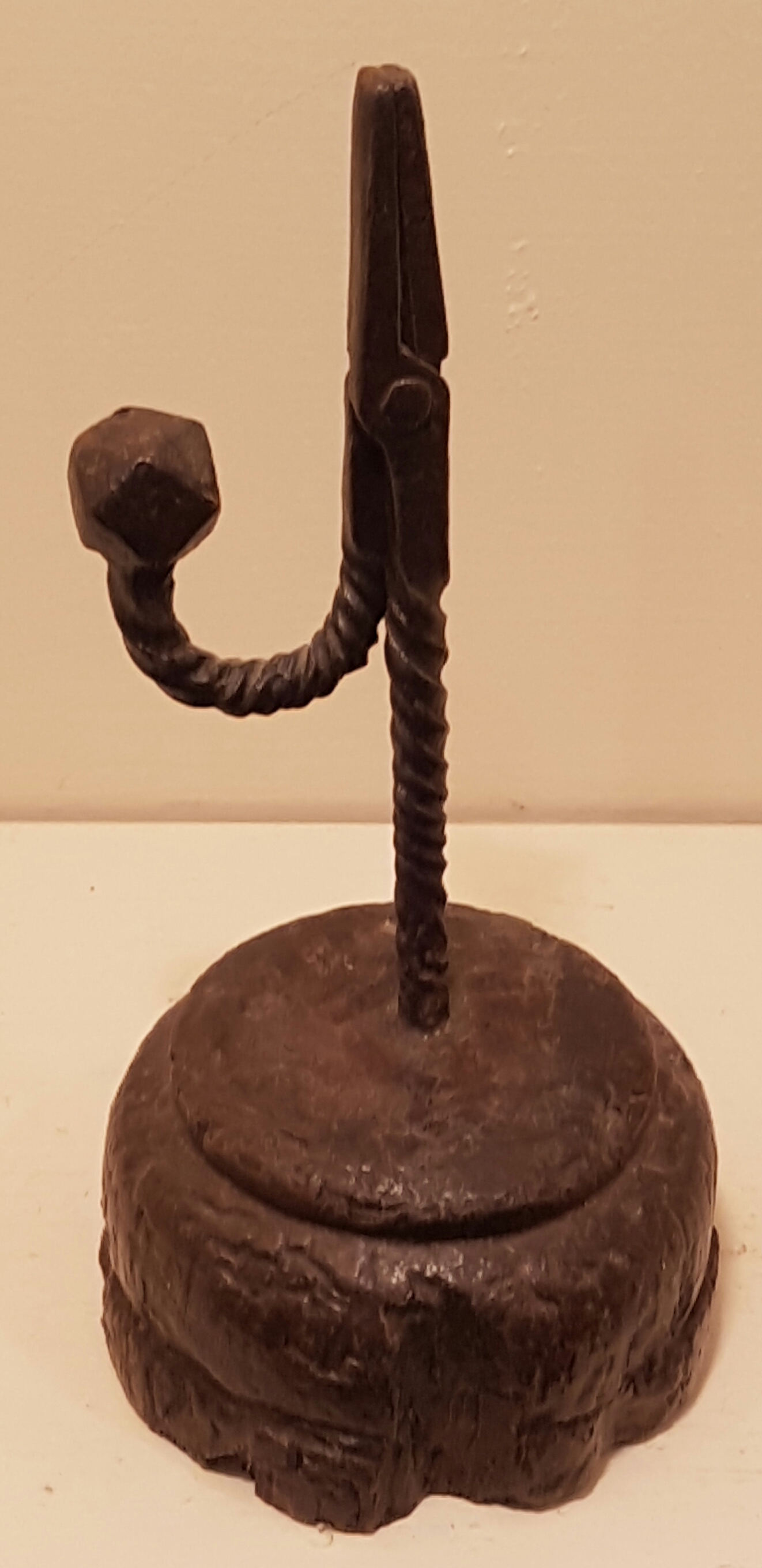 A 17TH/18TH CENTURY IRON TABLE RUSHLIGHT The stem and 'U' form arm, with deep spiral and multi