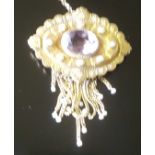 A VICTORIAN 18CT BLOOMED GOLD, AMETHYST AND PEARL MOURNING BROOCH/LOCKET The oval panel brooch is in