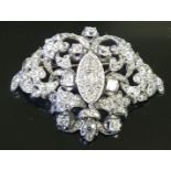 A 19TH CENTURY DIAMOND SET OPENWORK SCROLL BROOCH The central marquis shaped panel inset with a rose