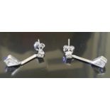 A PAIR OF HALLMARKED 18CT WHITE GOLD AND DIAMOND DROP EARRINGS The collet set kite cut diamonds,