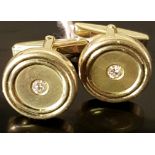 A PAIR OF 14CT GOLD CUFFLINKS Of circular form, inset with single diamonds.