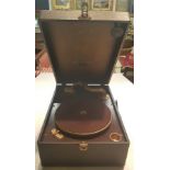 A VINTAGE COLUMBIA PORTABLE GRAMOPHONE With a black leatherette outer case and brown velvet