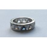 A PLATINUM, DIAMOND AND SAPPHIRE FULL ETERNITY RING The platinum mounted full eternity ring of 21