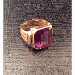 A 14CT GOLD HEAVY SIGNET RING Inset with an emerald cut pale purple topaz (size V).