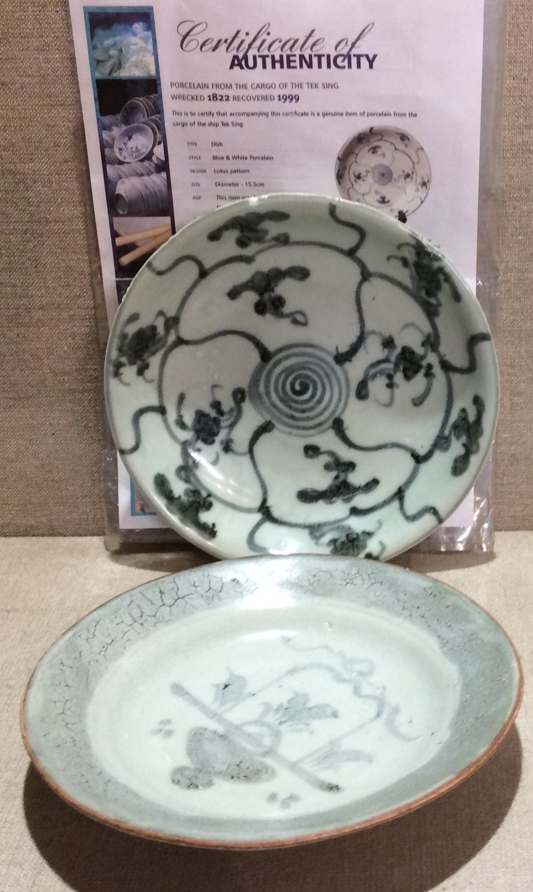 TEKSING, TWO EARLY 19TH CENTURY CHINESE PORCELAIN CHARGERS Hand painted with a lotus pattern and a