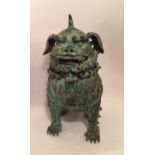 A 19TH CENTURY GREEN VERDIGRIS PATINATED CHINESE BRONZE INCENSE BURNER In the form of a Kylin. (