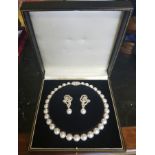 A SOUTH SEA PEARL AND DIAMOND NECKLACE AND MATCHING EARRINGS The knotted string of thirty-one