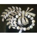 A HEAVY MID 20TH CENTURY PLATINUM, DIAMOND AND PEARL BROOCH The foliate spray and ribbon design, the