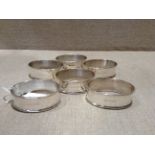 A SET OF SIX HALLMARKED SILVER OVAL NAPKIN RINGS With raised edges and plain central bands,