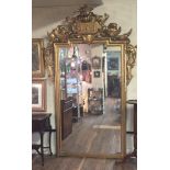 A 19TH CENTURY ITALIAN GILT FRAMED MIRROR Crested with scrolls above a silvered plate.