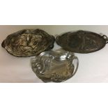 W.M.F., AN ART NOUVEAU PERIOD THREE GERMAN SILVER PLATE ON PEWTER TRAYS A child gazing at a snail,