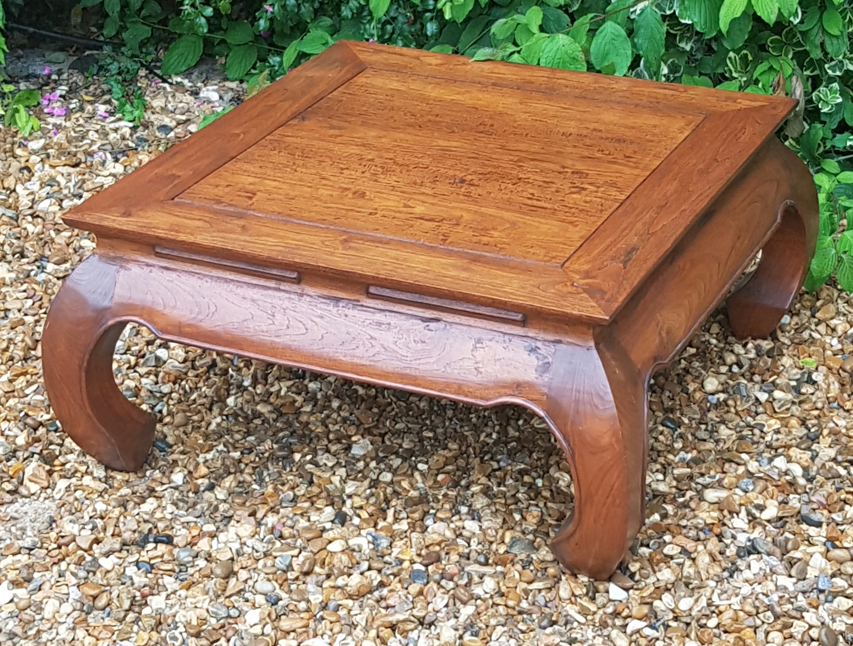 A CHINESE HARDWOOD SQUARE COFFEE/TEA TABLE Raised on square under scroll legs.