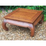 A CHINESE HARDWOOD SQUARE COFFEE/TEA TABLE Raised on square under scroll legs.