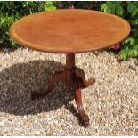 A 19TH CENTURY MAHOGANY AND CROSSBANDED CIRCULAR TILT TOP SUPPER TABLE Raised on cannon barrel