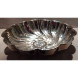 A LARGE EDWARDIAN SILVER FRUIT BOWL With spiralling fluted design, with an embossed design to