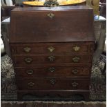 AN EARLY 18TH CENTURY STRAIGHT GRAINED WALNUT BUREAU The fall front enclosing a fitted drawer with