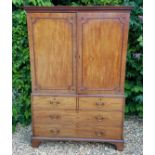 A GEORGIAN MAHOGANY HANGING CUPBOARD The dentil cornice above two doors, enclosing hanging space and