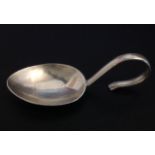 A MID 20TH CENTURY HALLMARKED SILVER CADDY SPOON The bowl of plain oval form and the handle with