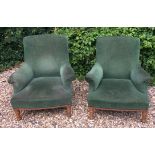 A PAIR OF LATE 19TH CENTURY FRENCH OAK ARMCHAIRS With green velvet upholstery, resting on turned