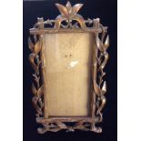 A 19TH CENTURY CONTINENTAL CARVED OAK EASEL/PICTURE FRAME Rectangular shape with bamboo