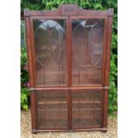 A REGENCY PERIOD MAHOGANY BOOKCASE The marquetry inlaid cornice, above four glass doors flanked by