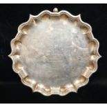 AN ENGLISH HALLMARKED SILVER CARD TRAY With scalloped edge, bears various inscriptions.