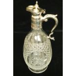 AN EARLY 20TH CENTURY CUT GLASS CARAFE With white metal mounts. (30cm)