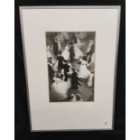 A VINTAGE BLACK AND WHITE PHOTOGRAPHIC PRINT Of a crowded dance floor, the gentlemen wearing white