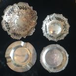 AN ENGLISH SILVER ASHTRAY Along with pierced bonbon dishes and one other.