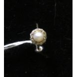 AN ANTIQUE 18CT GOLD RING With central pearl surrounded by diamonds.