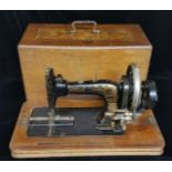 A LATE VICTORIAN SINGER SEWING MACHINE In Tunbridge ware carrying case.