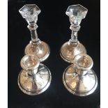 A PAIR OF SQUAT ENGLISH HALLMARKED CANDLESTICKS Along with another crystal candlesticks, on silver