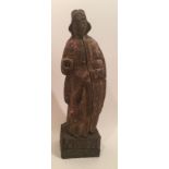 A 16TH/17TH CENTURY CARVED WOODEN STATUE Of a saintly figure, on a later stand. (26cm)